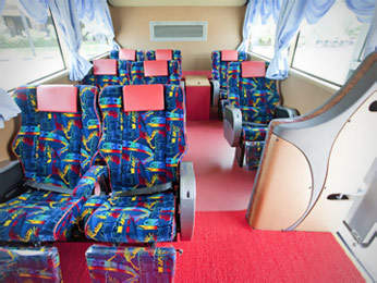 Wider seat on bus with 3 seats in a row configuration